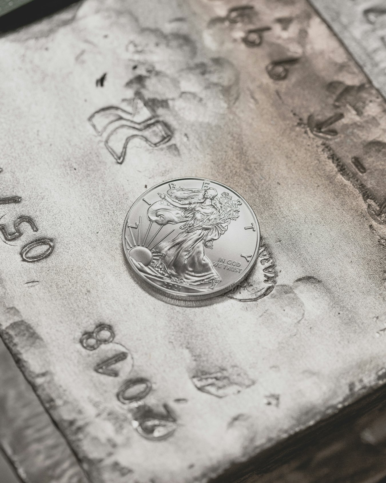 A silver coin resting on a wooden table