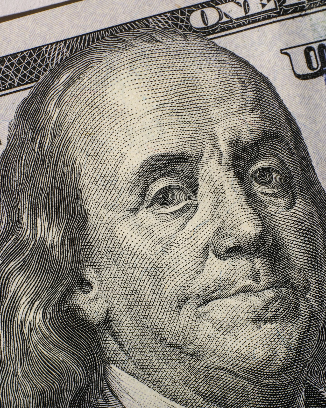 Close-up of the engraved portrait on a United States one hundred dollar note