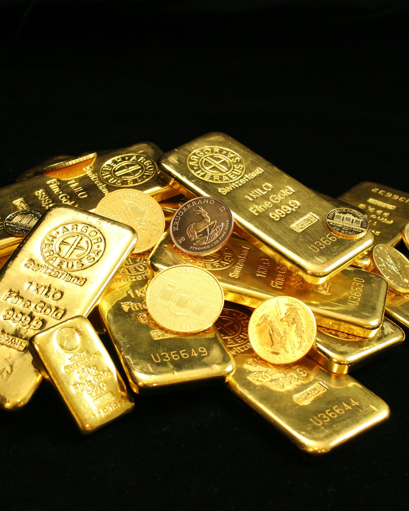 Gold bars and coins on a dark background